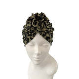 Leopard print headscarf on a mannequin head against a white background