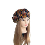 Mannequin head with a patterned beret on a white background