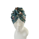 Floral patterned headscarf on a mannequin head against a white background