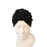 Black headscarf on a mannequin head against a white background