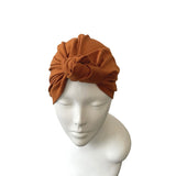 rust headband on a mannequin head against a white background