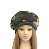 Camouflage beret on a mannequin head with long hair against a white background