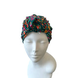 Floral patterned headscarf on a mannequin head against a white background