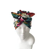 Colorful headscarf on a mannequin head against a white background