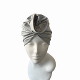 Gray headscarf on a mannequin head against a white background