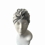 Gray headscarf on a mannequin head against a white background