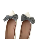 White shoes with gray bow decorations on a white background