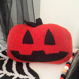 Halloween-themed pillow with jack-o'-lantern design on a decorative background