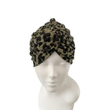 Leopard print headscarf on a mannequin head against a white background