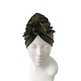 Green headscarf on a mannequin head against a white background