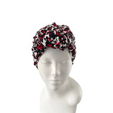 Patterned headscarf on a mannequin head against a white background