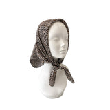 Leopard print headscarf on a mannequin head against a white background