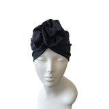 navy headscarf on a mannequin head against a white background