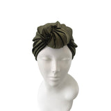Green headband on a mannequin head against a white background
