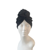 Black headscarf on a mannequin head against a white background