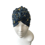 Blue patterned headscarf on a mannequin head against a white background