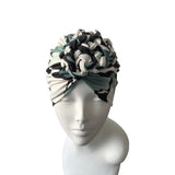Turban with geometric pattern on a mannequin head against a white background