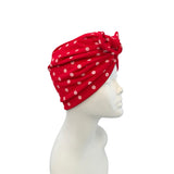 Red polka dot headscarf on a mannequin head against a white background