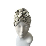Turban with leaf pattern on a mannequin head against a white background