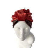 Red headscarf on a mannequin head against a white background