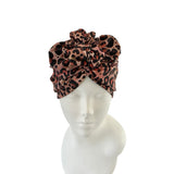 Leopard print headscarf on a mannequin head against a white background