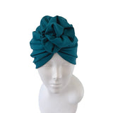 Teal headscarf on a mannequin head against a white background