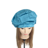 Blue textured beret on a mannequin head with brown hair against a white background