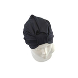 Black swim cap on a mannequin head against a white background