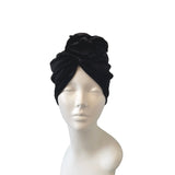 Black headscarf on a mannequin head against a white background