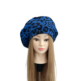 Blue leopard print headscarf on a mannequin head with long hair against a white background