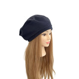 navy beret on a mannequin head with long brown hair against a white background