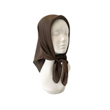 Brown headscarf on a mannequin head against a white background