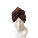 Brown headscarf on a mannequin head against a white background