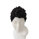 Black headscarf with floral design on a mannequin head against a white background