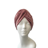 Mauve headscarf on a mannequin head against a white background
