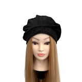 Black beanie on a mannequin head with blonde hair against a white background
