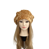 Mannequin head with a gold patterned headscarf on a white background