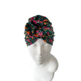 Floral patterned headband on a mannequin head against a white background