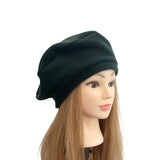 green beanie on a mannequin head with long brown hair against a white background