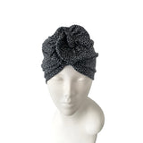 Black patterned headscarf on a mannequin head against a white background