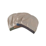 Beige shower cap with colorful accents on a white background