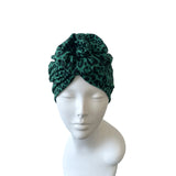 Green leopard print headscarf on a mannequin head against a white background