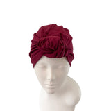 Maroon headscarf on a mannequin head against a white background