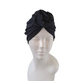 Black headscarf on a mannequin head against a white background