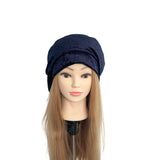Navy blue headscarf on a mannequin head with long blonde hair against a white background