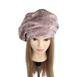 Mannequin head with a purple velvet turban on a white background