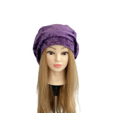 Purple turban on a mannequin head with long blonde hair against a white background