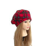 Red plaid hat on a mannequin head with long brown hair against a white background