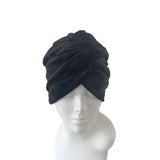 Black velvet turban on a mannequin head against a white background