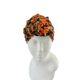 Floral patterned headscarf on a mannequin head against a white background